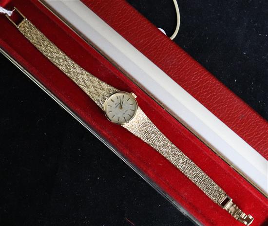 A ladys 9ct gold Omega De Ville wristwatch, with integral textured bracelet, circa 1970, cased with guarantee.